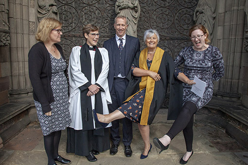 Canon Julie, robed, in a celebratory mood outside Lichfield Cathedral