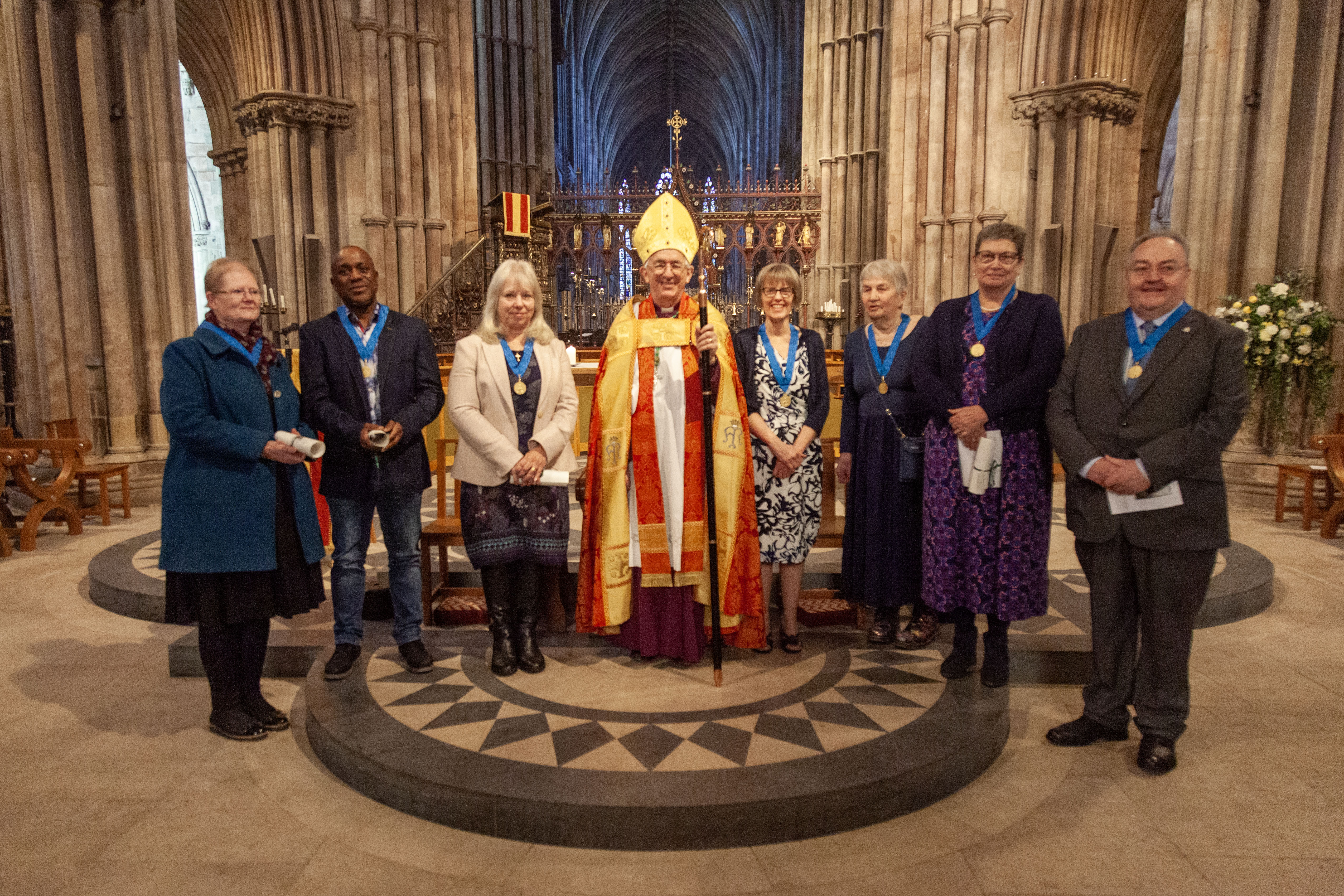 The seven recipients of St Chad Medals with Bishop Michael Ipgrace stood in front of the nave altar in Lichfield Cathedral