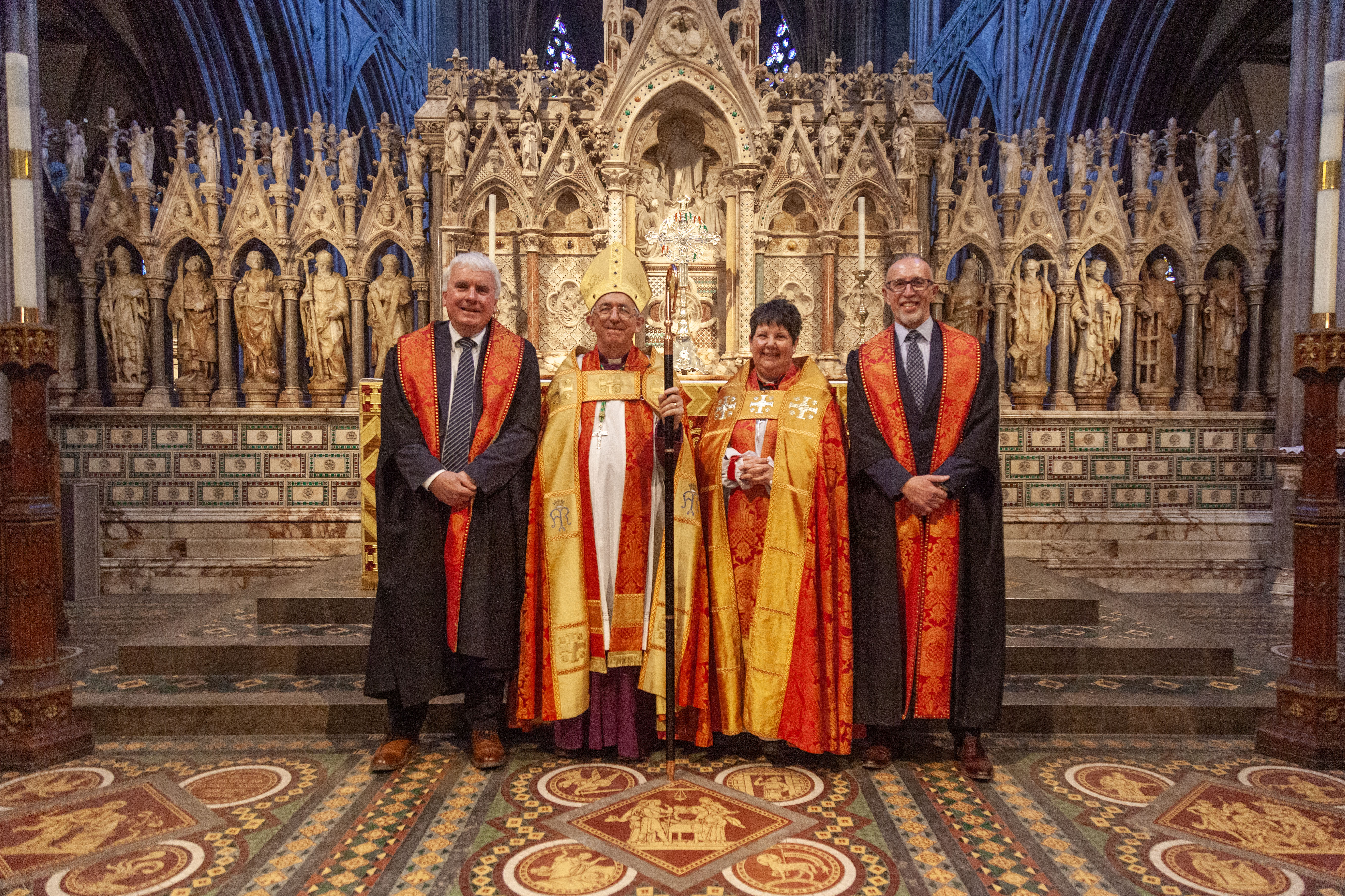 Eric Lunt, Bishop Michael, Bishop Jan (the Dean) and Lloyd Cooke stood in front of the high altar, Lichfield Cathedral