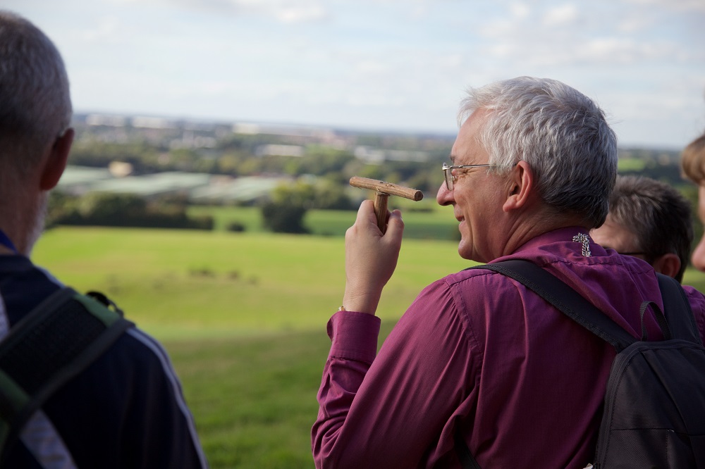 Bishop Michael Ipgrave taking in view over Stafford holding a Mequamia, a simple prayer stick